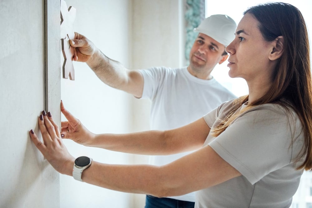 Amiddle agedwomaninwhitet shirtcarefullyapplydecorativeelement | custom home builder in texas | luxury custom home builder